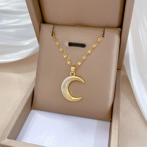 Luxurious gold crescent moon pendant necklace with white enamel and sparkling crystals