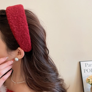 Detail of red plush wide headband with warm texture and elegant winter vintage style