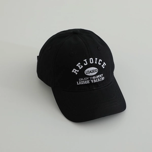 Detailed close-up of white embroidery on a black cotton baseball cap for boys