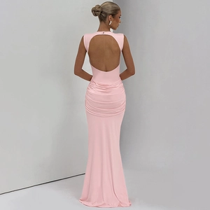 Close-up of pink backless dress with ruched details and an elegant cutout floor-length hem