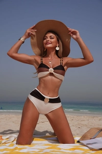 Detail of seashell metal clasp and beaded straps on a two-piece patchwork bikini set