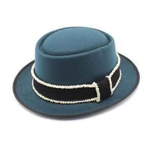 Deep teal wool pork pie hat with black ribbon and white bead trim for a vintage look