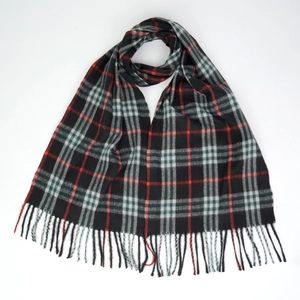 Close-up of classic black plaid scarf texture with soft grey red lines and fringe details