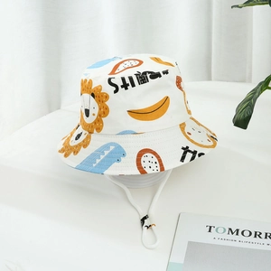 White kids bucket hat with cartoon lions and dinosaurs featuring adjustable chin strap