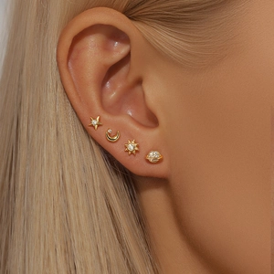 Macro view of gold S925 silver celestial stud earring set featuring stars and planets