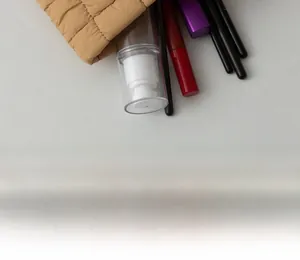 Detailed internal view of brown quilted cosmetic bag showing storage of makeup tools
