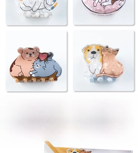 Detailed close-up of colorful acrylic hair claws featuring cute cartoon cat and dog designs