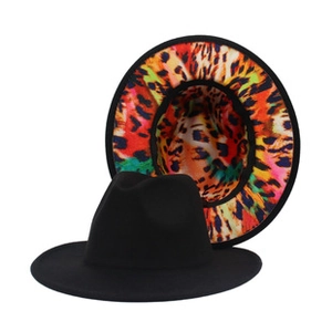 Detail of black fedora hat featuring vibrant multicolor leopard print lining under the brim
