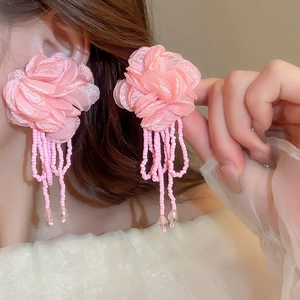 Detail of pink chiffon flower earrings with beaded tassels and crystal accents