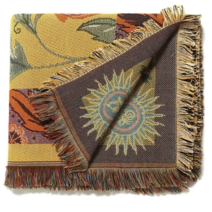Close-up of thick woven camping blanket featuring bohemian floral patterns and fringed edges