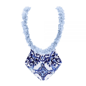 Detail of blue and white porcelain pattern on one-piece swimsuit with ruffle trim
