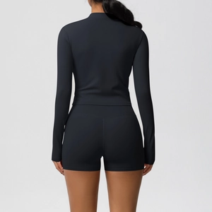 Back view of a black yoga set featuring a tight long-sleeve top and high-waist shorts
