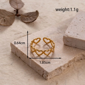Minimalist adjustable hollow heart ring in gold finish on a rustic stone background