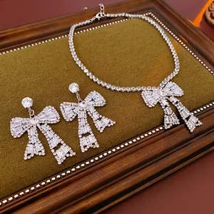 Luxury silver-tone bowknot jewelry set featuring a tennis necklace and drop earrings