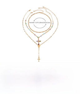 Detail view of multi-layer gold alloy necklace with cross pendant and colorful beads