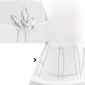 Detail showing shiny crystals and flexible silver alloy material of the hair pin