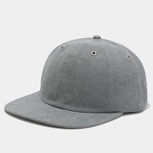 Detailed close-up of grey twill baseball cap with silver metal eyelets and fine stitching