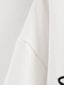 Close-up of white heavy cotton twill fabric showing detailed stitching and premium texture