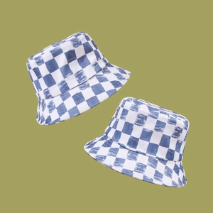 Stylish blue and white checkered bucket hat with trendy tie-dye denim texture