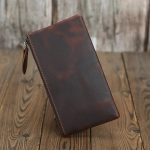 Detail of vintage dark brown crazy horse leather wallet with sturdy zipper closure