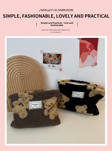 Detail view of teddy bear plush cosmetic bags with golden zippers in brown and black