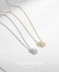 Close-up of elegant gold and silver intertwined knot necklaces with sparkling pavé crystals