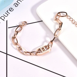 Close-up of rose gold stainless steel chain bracelet with hollow oval B letter charm