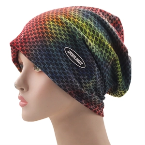 Close-up of rainbow gradient knit beanie featuring a breathable honeycomb mesh texture