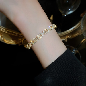 Detail of gold-plated chain bracelet with micro-pave cubic zirconia on a wrist