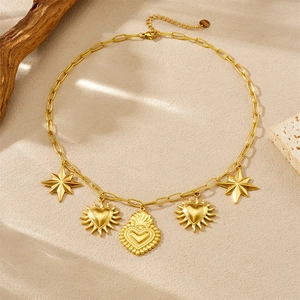 Gold eight-pointed star and heart stainless steel necklace on minimalist stone background