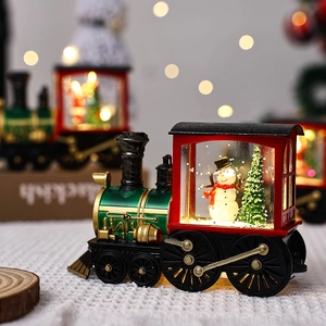 Close-up of Christmas water-filled train night light with snowman and tree inside