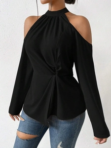 Detail of black cold shoulder long sleeve top with stylish halter neck and waist knot