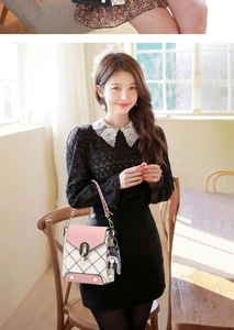 Detail of crossbody phone bag with quilted stitch pattern and cute bear keychain charm