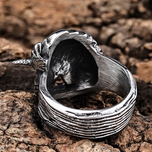 Retro stainless steel unicorn skull ring with vintage brushed finish on wood bark