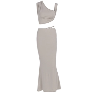 Detail of grey two-piece set featuring a one-shoulder crop top and tie-waist maxi skirt