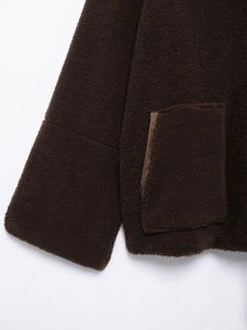 Detail of deep brown teddy fleece sleeve cuffs and side pocket stitching quality