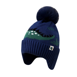 Winter knit hat for boys with fleece lining and green dinosaur pattern in dark blue