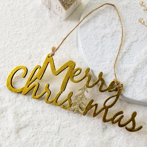 Golden glitter Merry Christmas wooden sign with tree shape and rustic rope on snow