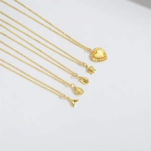 Detail view of five assorted gold-tone necklaces with diverse nautical and heart pendants