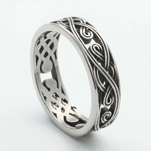 Macro shot of retro Celtic knot patterns on vintage silver titanium steel ring