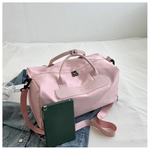 Pink waterproof yoga bag with HAPPY BAG label next to a tablet for size reference