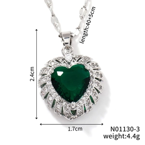 Detailed view of heart pendant with green gemstone and white zircon including size info