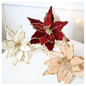 Close-up of velvet poinsettia flowers with gold glitter edges for Christmas decor