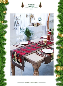 Detailed embroidery of Christmas trees and elk on a red and black plaid cotton linen table runner