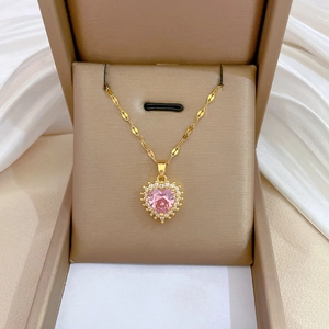 Detail of pink heart crystal necklace with white diamonds in brown gift box