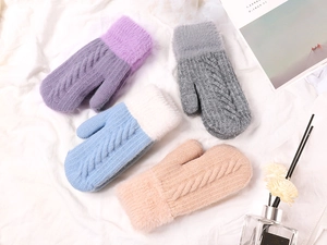 Detailed cable knit patterns on multi-colored winter gloves with soft faux fur cuffs