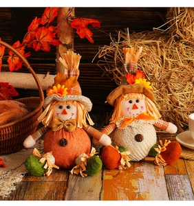 Detail of harvest scarecrow gnomes on rustic wood with maple leaves and pumpkins