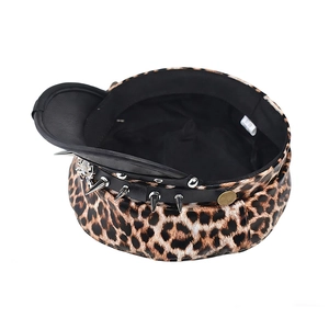 Close-up of leopard newsboy hat with silver spikes and spider charm on black leather brim