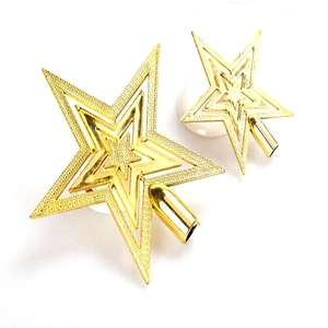 Two golden hollow Christmas tree star toppers with frosted texture on white background