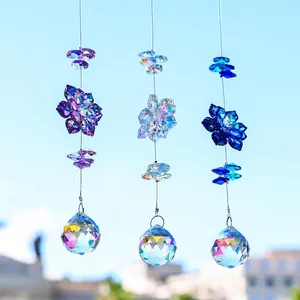 Three crystal suncatchers with maple leaf glass beads hanging against a clear blue sky